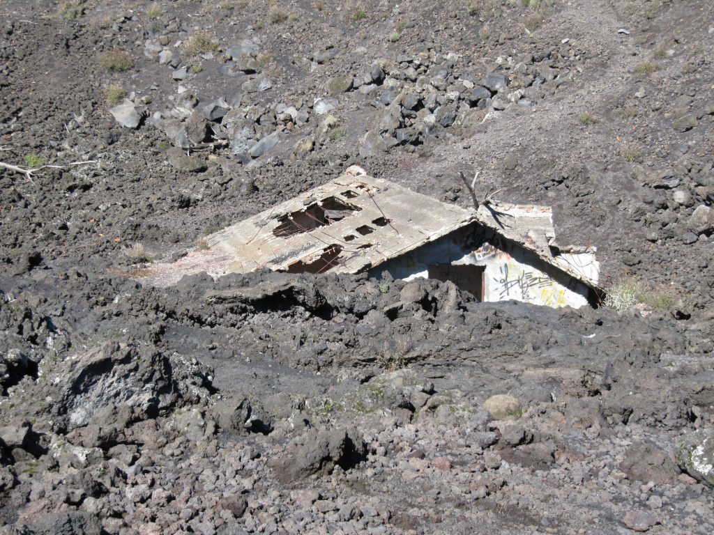 Huisje onder de gestolde lava op de Etna